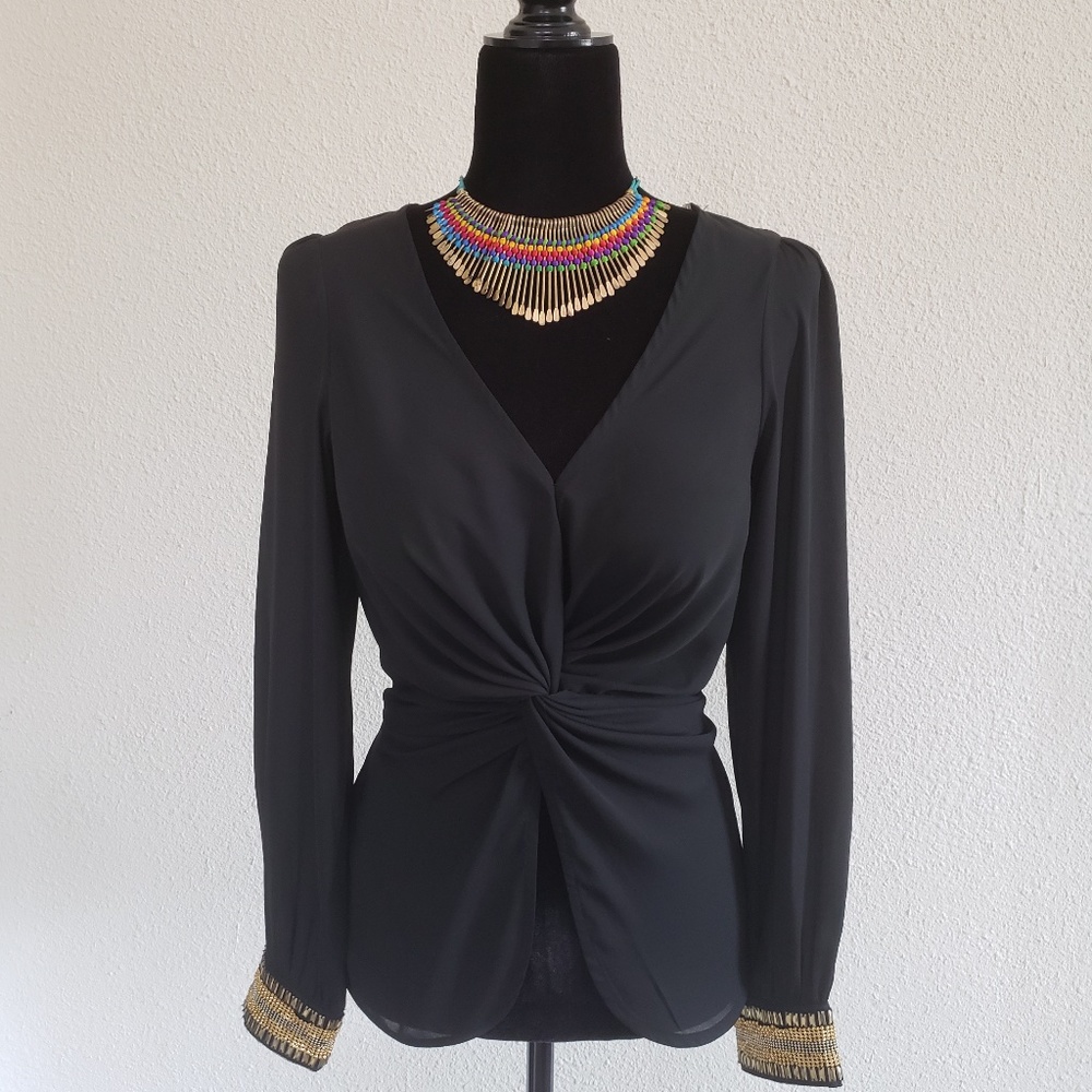 Sheer black blouse with gold cuffs